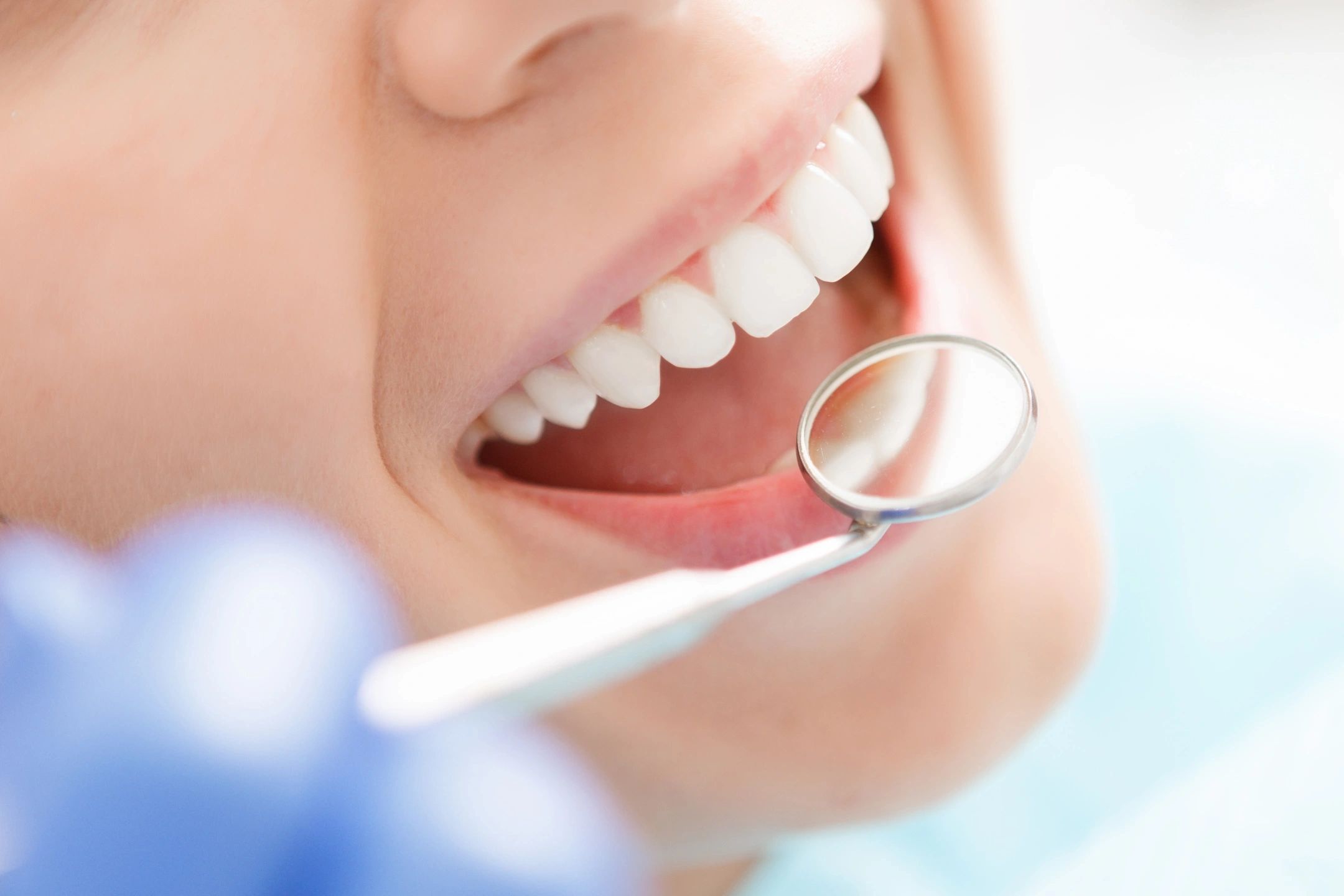 Dentist examining a patient's teeth during an oral health checkup